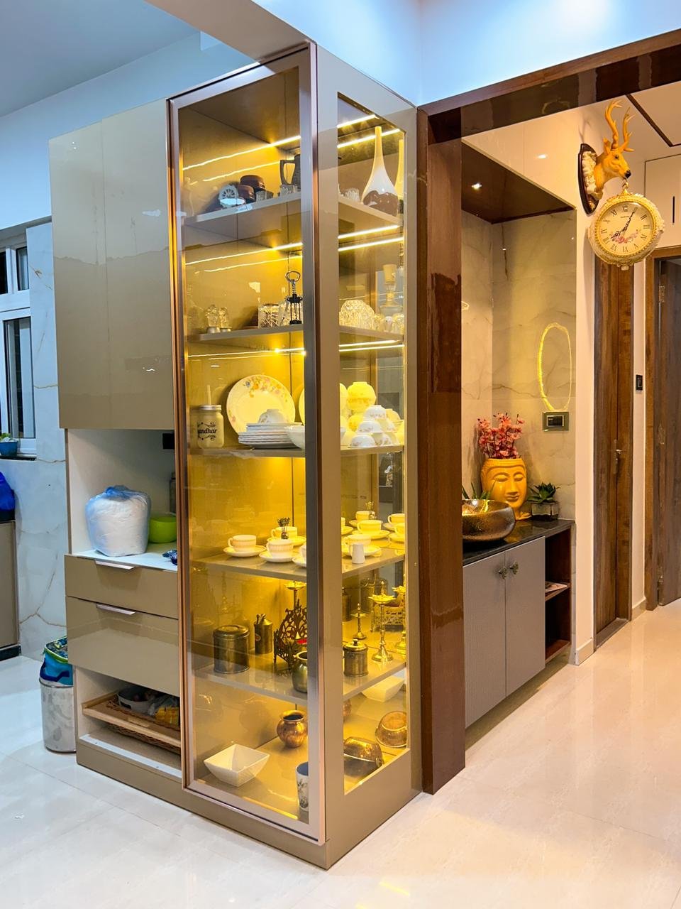 Illuminated luxury display cabinet with brass toned framing by Doric & Co. Pune